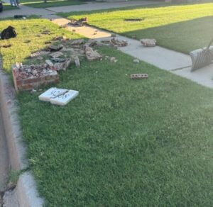 Destroyed brick mailbox structure before reconstruction
