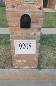 Finished brick mailbox rebuild with black mailbox and white address panel